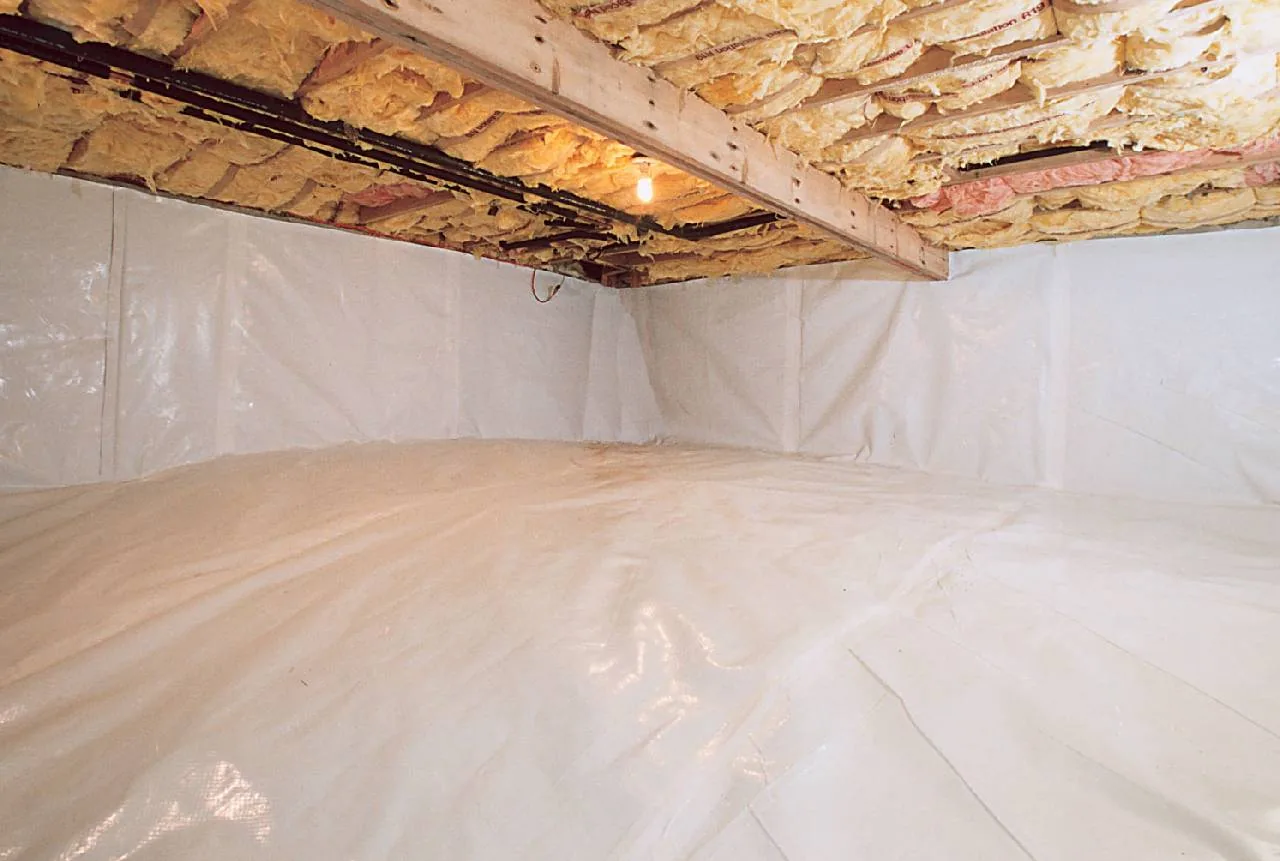 Fully encapsulated crawl space with white vapor barrier over ground and walls