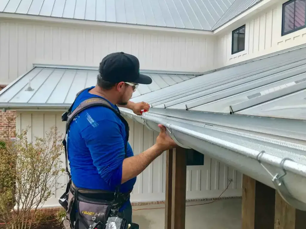 Seamless gutter and downspout directing roof water away from a home's foundation